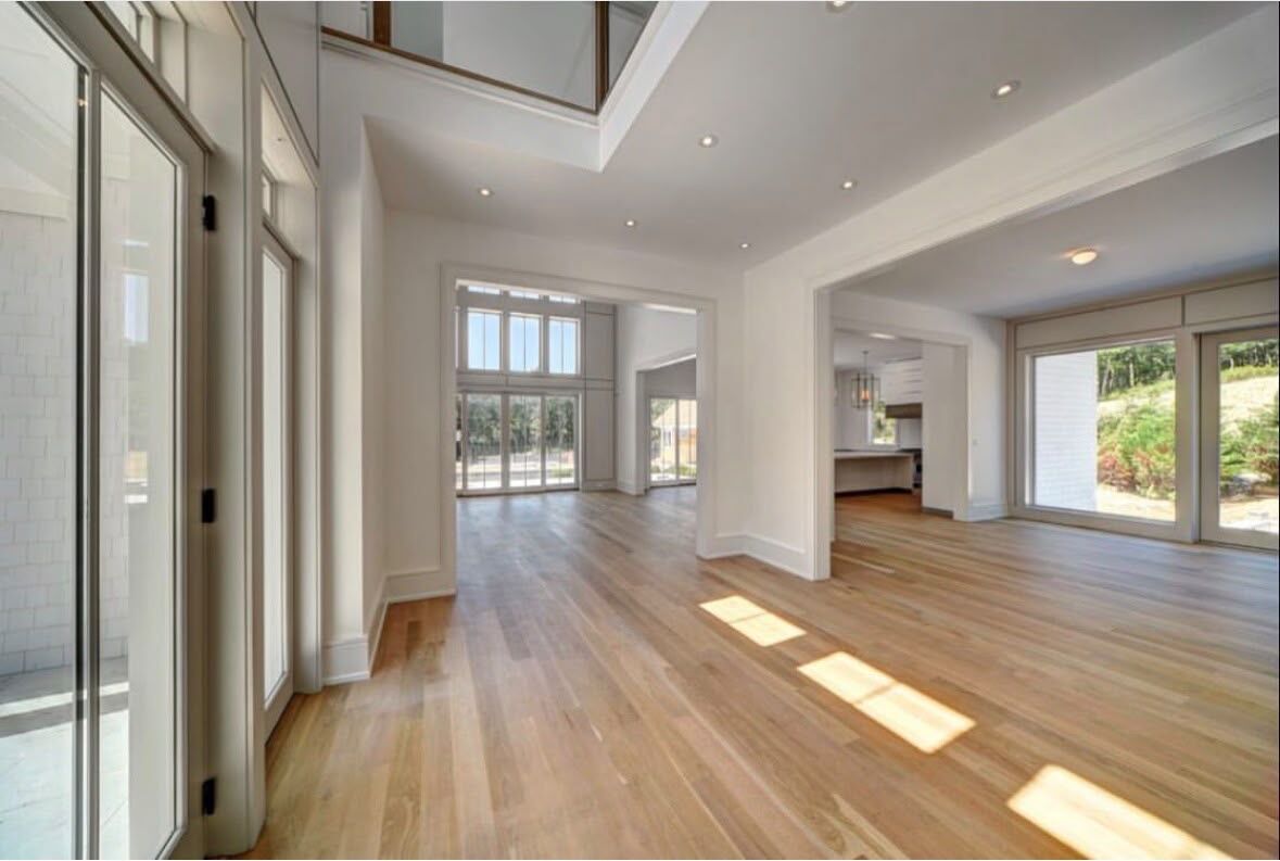 Entry hall with wide cased openings and continuous baseboard