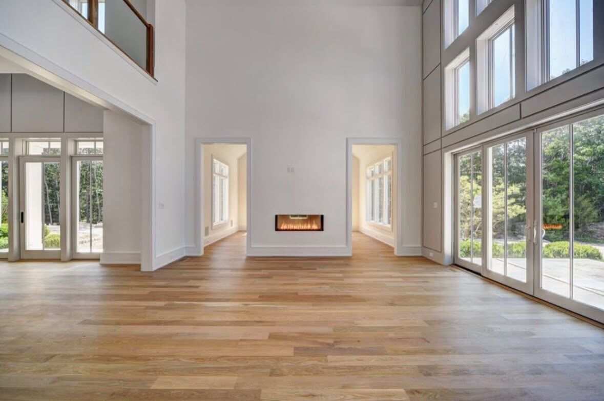 Matching cased openings on either side of a linear fireplace wall