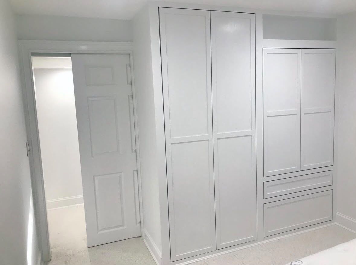Painted built-in wardrobe with Shaker-style doors and drawers