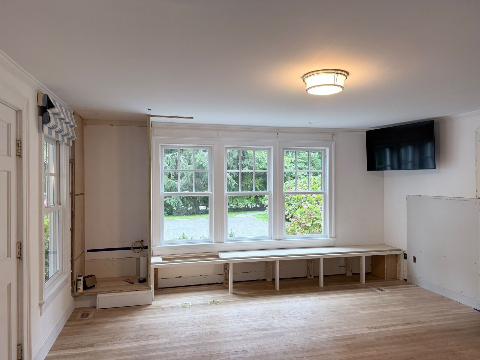 Window seat and cabinet framing in progress during a room renovation